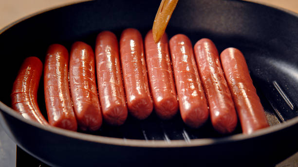 istock Fried sausages in a pan on the stove. 1369721106