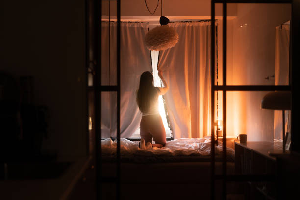 istock Opening up the curtain in the bedroom 1369721504
