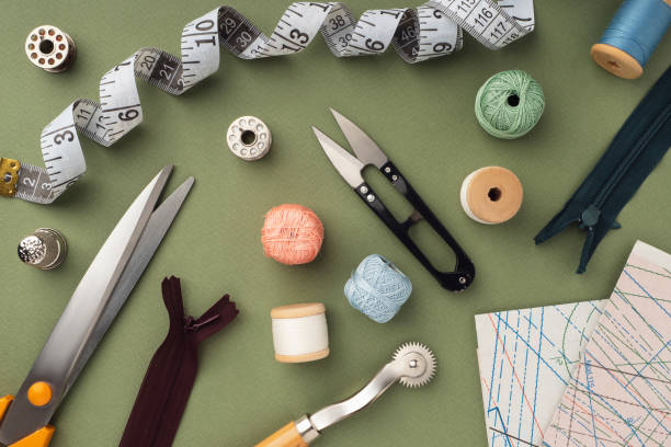 istock Pattern, fabric and sewing accessories on a green paper background, flat, lay, top view, copy space. A tailor or seamstress desk. Sewing concept, background. Tailoring of designer clothes 1369722306