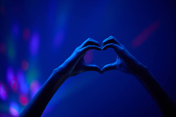 Cropped shot of an unrecognisable couple making a heart shaped gesture while at a concert We've got nothing but love heart hands multicultural women stock pictures, royalty-free photos & images