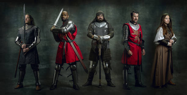 istock Creative art collage with brave serious medieval warriors and lady knight in armor clothes with wounded faces holding shield, sword isolated on vintage background. 1369722422