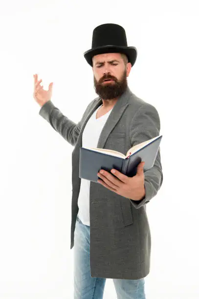 Photo of Literary criticism. Faced with senseless drama. Eloquence and diction. Bearded man read book. Poetry reading. Book presentation. Literature teacher. Books shop. Guy classic outfit read book