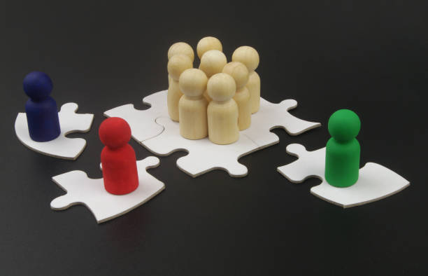 istock Wooden figures of people on jigsaw puzzles. 1369724928