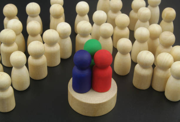 three different candidates or speakers - colored figures and many wooden figures as people listening them. - surrounding leadership organization meeting imagens e fotografias de stock