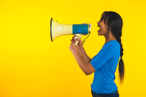 istock Young girl shouting with megaphone shouting! 1369726954