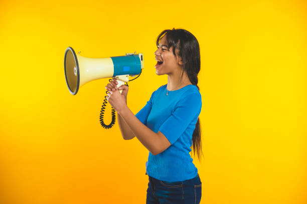 istock Young girl shouting with megaphone shouting! 1369727724