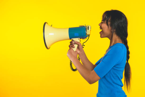 istock Young girl shouting with megaphone shouting! 1369727726