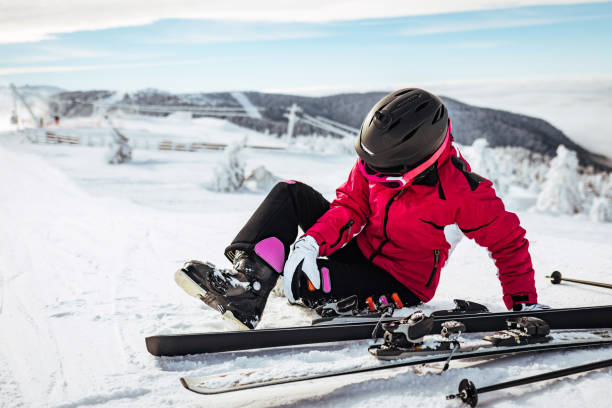 istock Female skier falling down on mountain slope. 1369727940