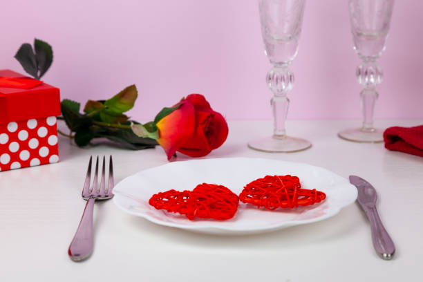 istock Valentine's day romantic dinner with red hearts 1369729281