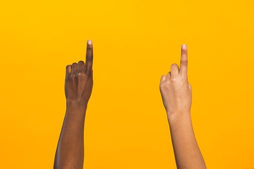 Diverse hands on yellow background