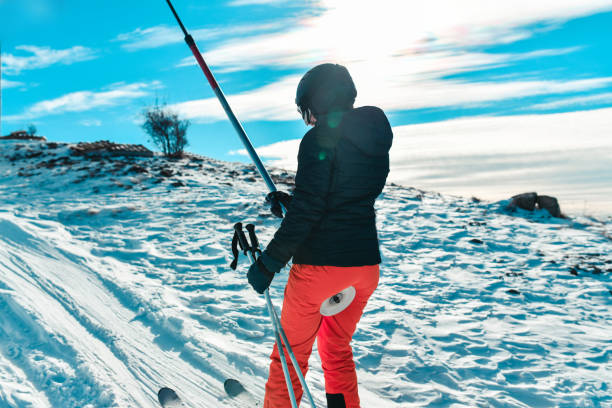 istock Rear View Of Skiing Female Using Ski Lift On Mountain 1369729821