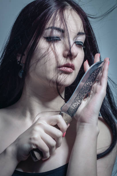 Cute asian girl with knife stock photo