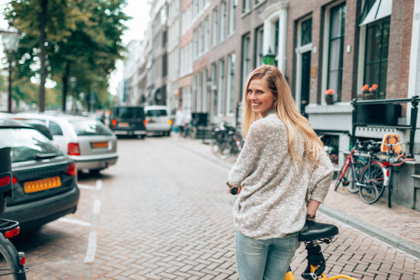 istock beautiful woman take a selfie in amsterdam 1369730610