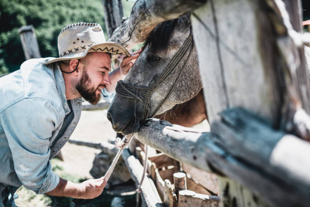 istock Smiling Bearded Rancher Spending Time With His Favorite Horse 1369733493