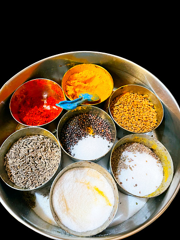 Traditional Indian kitchen box containing masalas and condiments.
