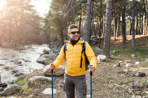 istock handsome mountaineer man, wearing sunglasses, hiking 1369734910
