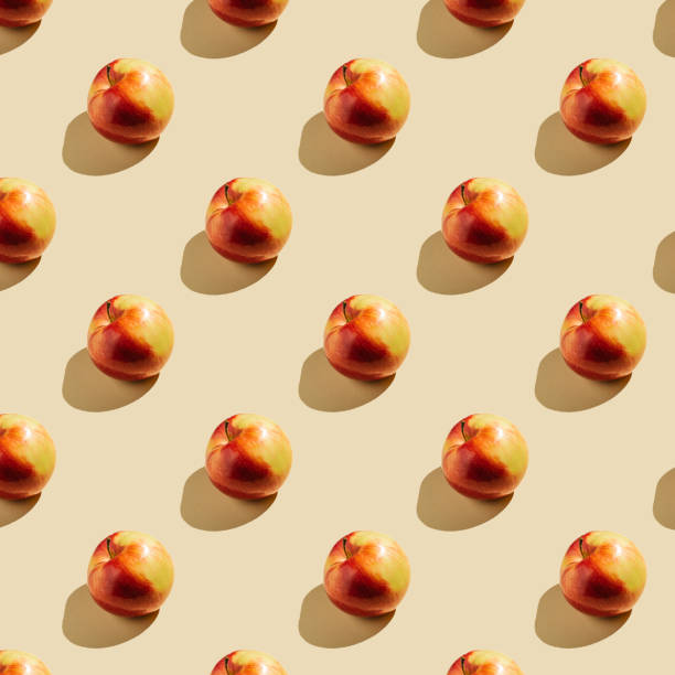 istock Pattern of apples on a beige background. 1369736396