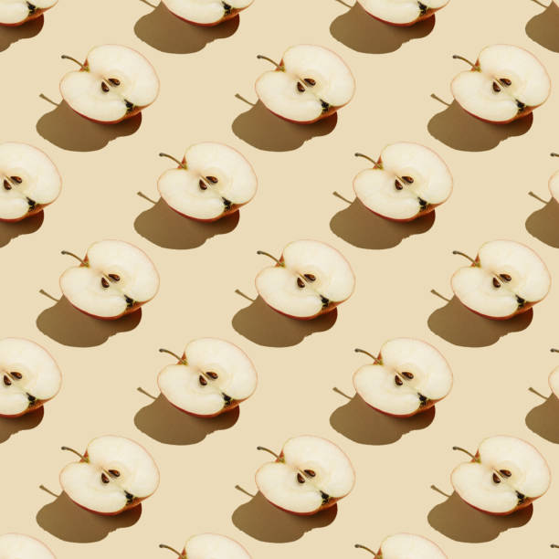 istock Pattern of apples on a beige background. 1369736423