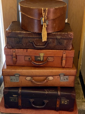 A pile of antique leather suitcases