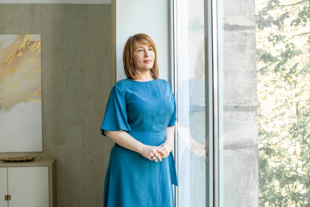 istock Nice casual middle-aged woman at home 1369739195