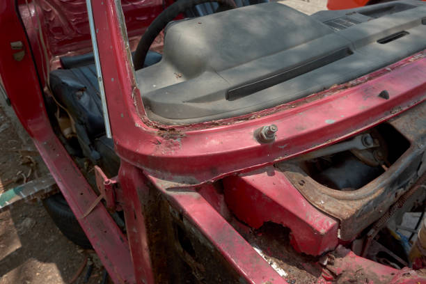 istock Old red car cab and used scrap metal at the ground 1369740102