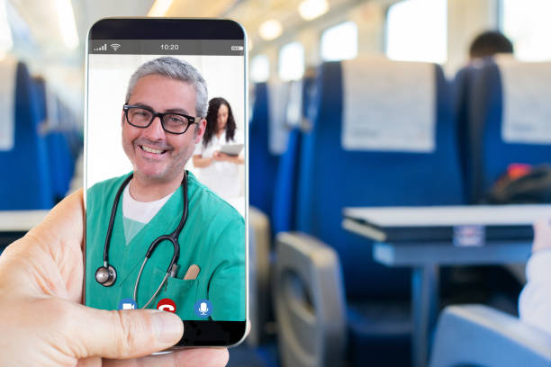 Man's hand making video call to his doctor from inside the train stock photo