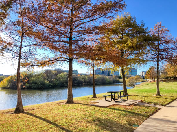 istock Peaceful riverside picnic table and corporate building offices along Trinity River near Dallas, Texas, America 1369743094