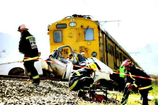 Stellenbosch, Western Cape, South Africa - 9 September 2009. Police and emergency workers clear the scene where a Metro passenger train travelling from Stellenbosch to Somerset West crashes into a car that was on the railway track.