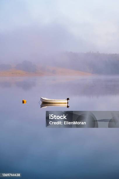 Small Boat Resting In The Calm Water Stock Photo - Download Image Now - Tranquility, Landscape - Scenery, Relaxation