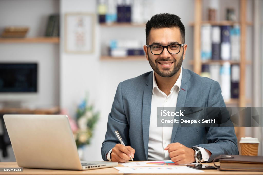 Portrait of a handsome young businessman working in office Portrait of a handsome young businessman working in an office Financial Advisor Stock Photo
