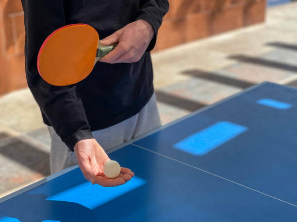 Table tennis player doing a serve. Ping pong game. Close up service on table tennis. Table tennis player doing a serve. Ping pong game. Close up service on table tennis table tennis free bet stock pictures, royalty-free photos & images