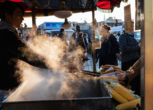 Istanbul, Turkey – Nov 20, 2021: street vendor selling Misir, a  freshly boiled or grilled sweet corn on the cob sprinkled with salt and spices