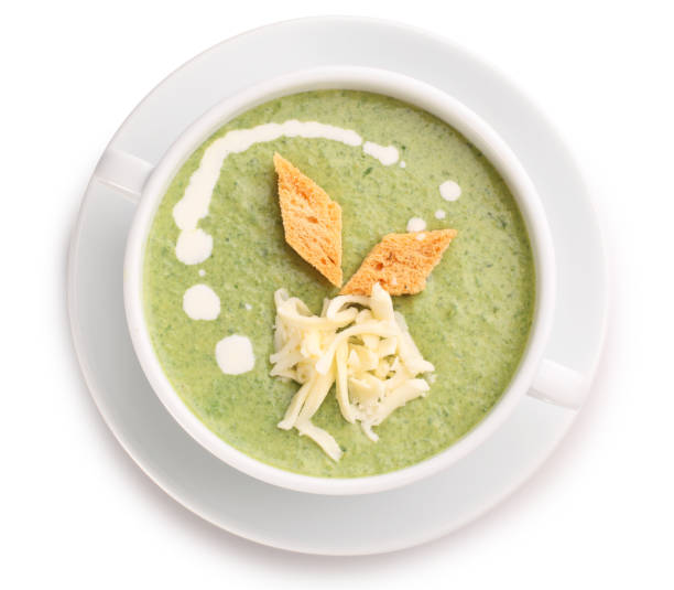istock Vegetable soup with spinach, cheese and croutons in a white plate on a white background. View from above. 1369747735