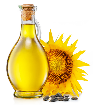 Bottle of sunflower oil, sunflower and seeds isolated on white background. The most popular of vegetable oils.