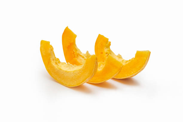 istock Three slices of ripe orange pumpkin isolated on white background 1369747869