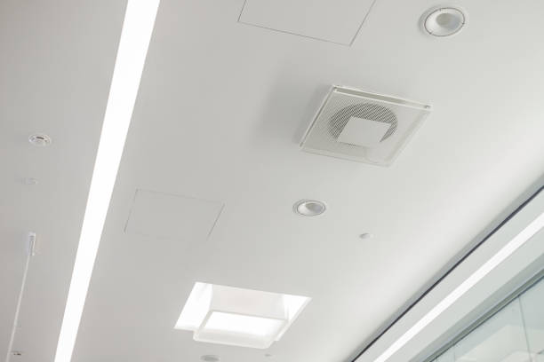 istock White plasterboard ceiling in administrative and public building with ventilation, lamps and speakers 1369748002