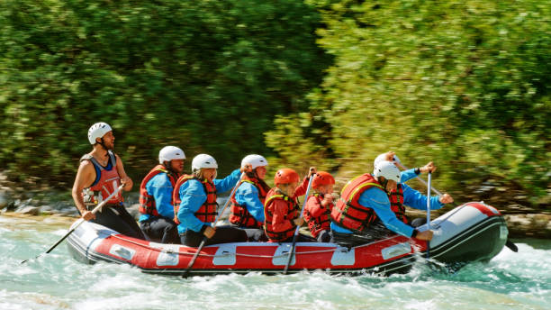 istock Rrafters paddling their raft in the river 1369748086