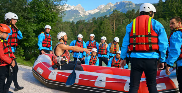 istock Rafting instructor teaching a group of people how to paddle raft 1369748095