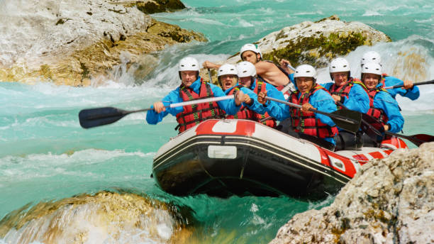 istock Whitewater rafters rowing their raft in the river 1369748096