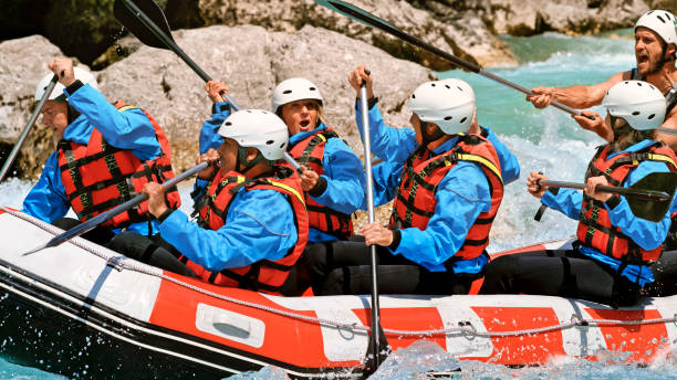istock Rrafters paddling their raft in the river 1369748138