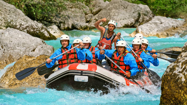 istock Whitewater rafters rowing their raft in the river 1369748144