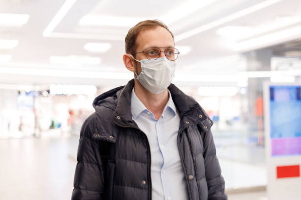 istock Caucasian man wearing face mask in mall 1369748153