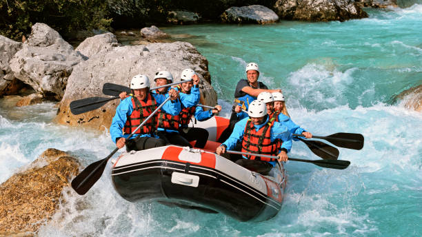 istock Whitewater rafters rowing their raft in the river 1369748191