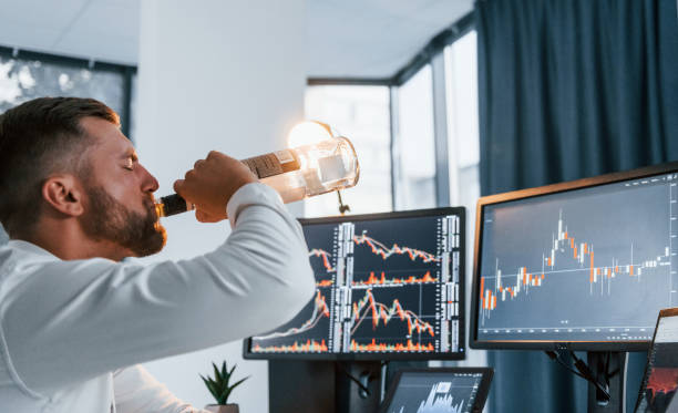istock Conception of failure. Young businessman in formal clothes is in office with multiple screens 1369748800