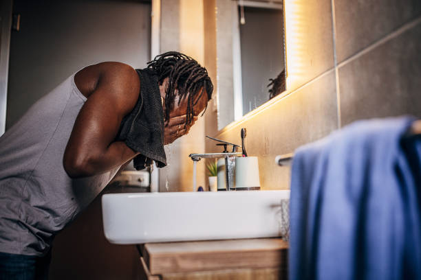 istock Man washing face in bathroom 1369749739