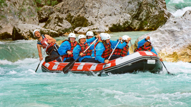 istock Whitewater rafters rowing their raft in the river 1369750637
