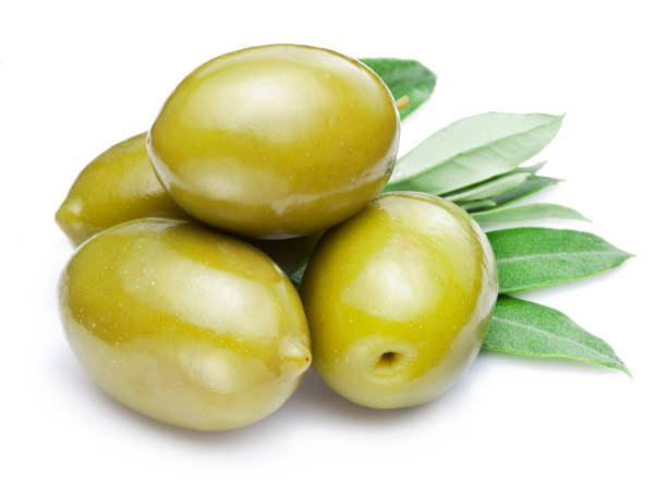 istock Green olives with leaves on white background. Close-up. 1369752550