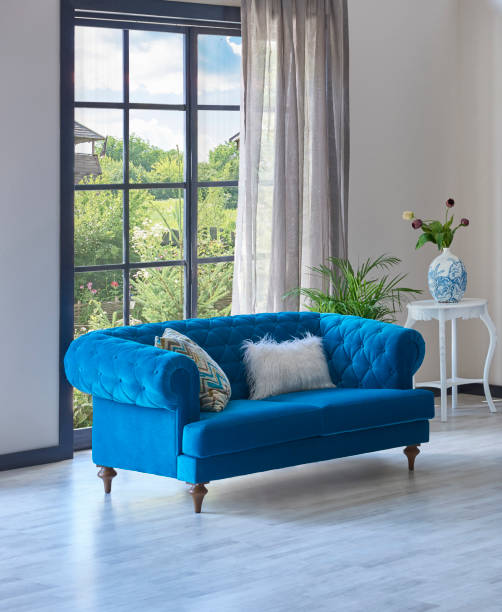 istock Carpet at home style with blue sofa parquet floor, home wall background lamp and table decoration. 1369753009