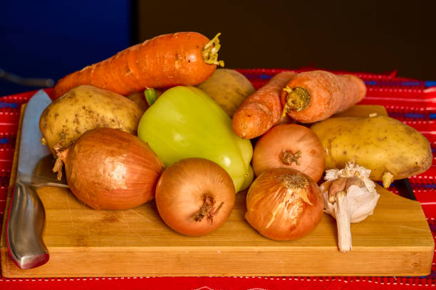 mixed vegetables on a wooden chopper on a table