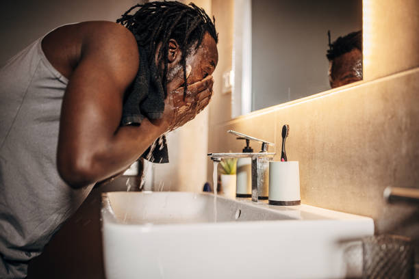 istock Man washing face in bathroom 1369756290